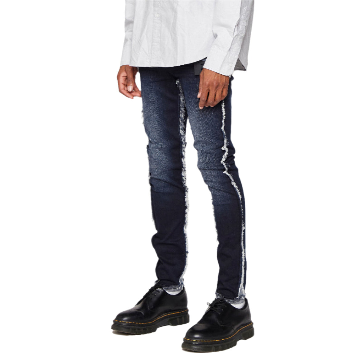 Person wearing blue jeans with white stripes on a white background