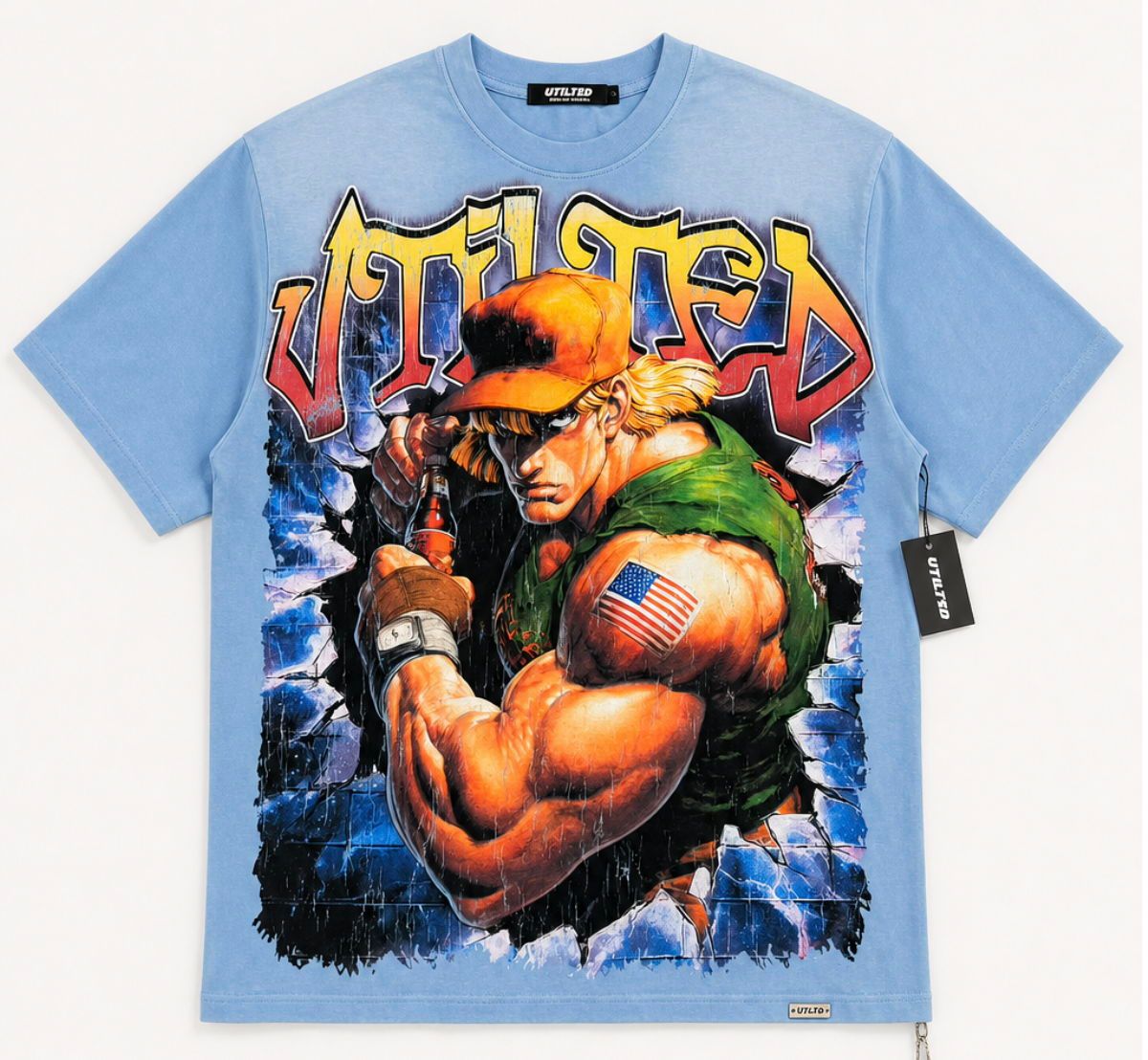 A light blue short-sleeve t-shirt featuring a large graphic print of the video game character Ken Masters from Street Fighter, with stylized 'UTILIZED' text across the chest, photographed flat against a light gray background.